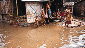 Family standing in polluted water.: Photograph courtesy of CDC.